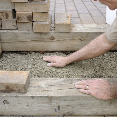 Worker Installing Brick Steps
