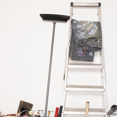 Stepladder and decorating equipment against wall