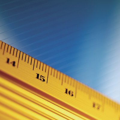Close-up of yellow ruler against blue and white background