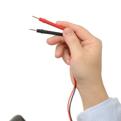 Electrician holding an electric meter