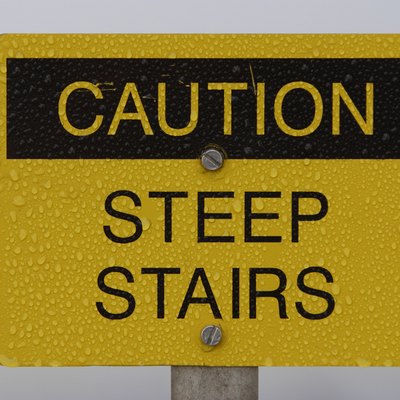 Scratched steep stairs warning sign