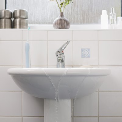 Overflowing sink in bathroom