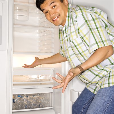 Man gesturing in front of refrigerator