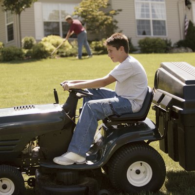 Boy on tractor mower