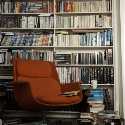 comfortable chair surrounded by books