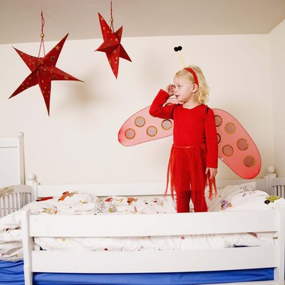 Girl in fairy costume on bunk bed