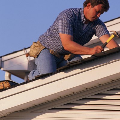 Man putting shingles on roof