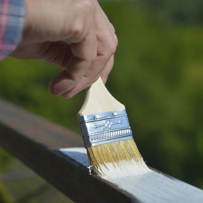 Man painting a guardrail