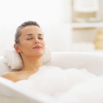 happy young woman relaxing in bathtub