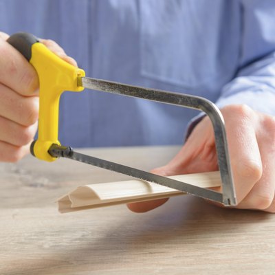 Cutting plastic molding with handsaw