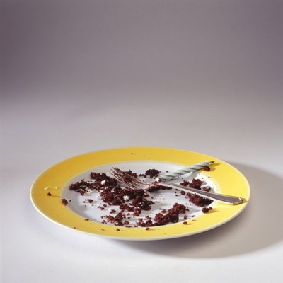 Empty plate with crumbs and candle, elevated view
