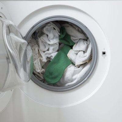white washing in machine one green sock