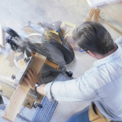 Construction worker using a miter saw