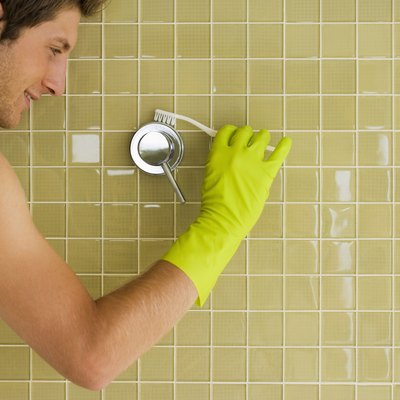 Man cleaning shower handle