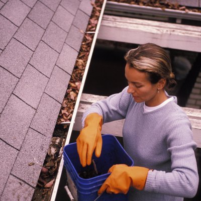 Woman Cleaning out Rain Gutters
