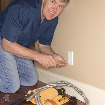 Man working on electrical outlet