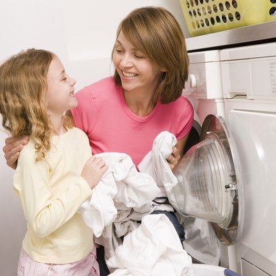 Woman doing laundry with child