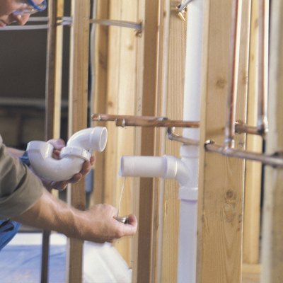 Plumber connecting PVC pipes