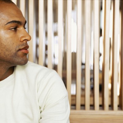 close-up of a young man looking through a window