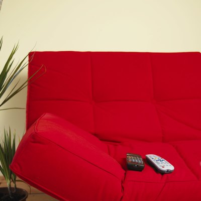 Remote controls on red sofa