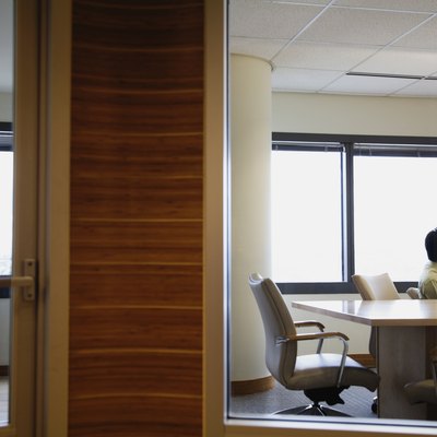 View through window to businesspeople working