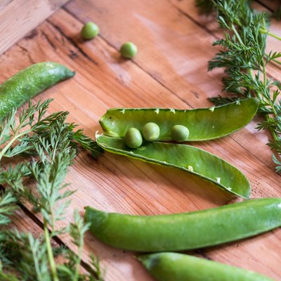 green snow peas in wooden box