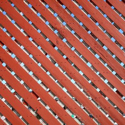 Pattern of wooden slats in chainlink fence