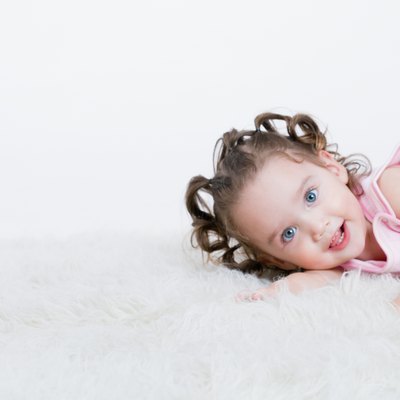 Studio shot of toddler on plush rug