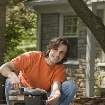 Smiling man with lawn mower