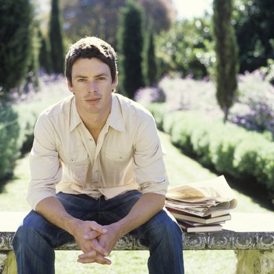 Man sitting on bench in garden, portrait