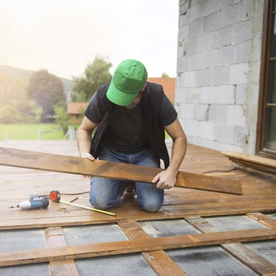 Handyman installing wooden flooring