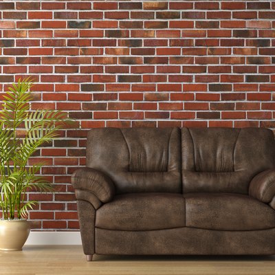 leather couch on brick wall