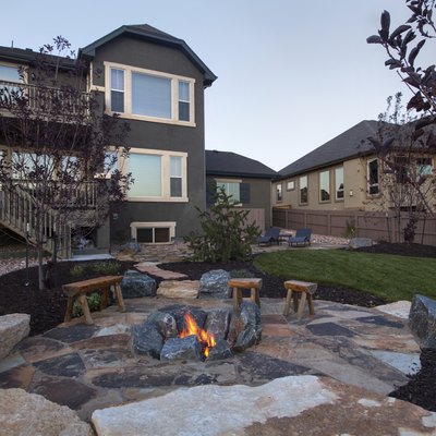 Landscaped backyard with beautiful Fire pit