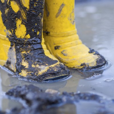 Yellow boots in puddle