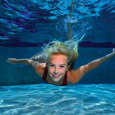 Girl swimming underwater.