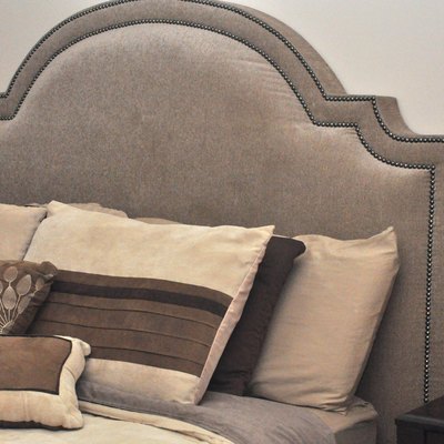 Bed with decorative headboard.