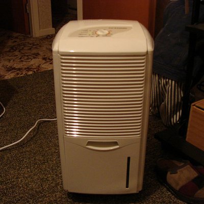 Air purifier in cluttered room.
