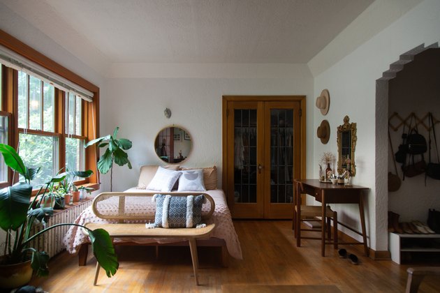 bedroom with wood floors, radiator, bureau