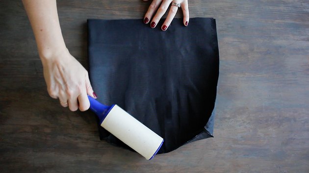 Lint rolling over fabric to remove dust or lint