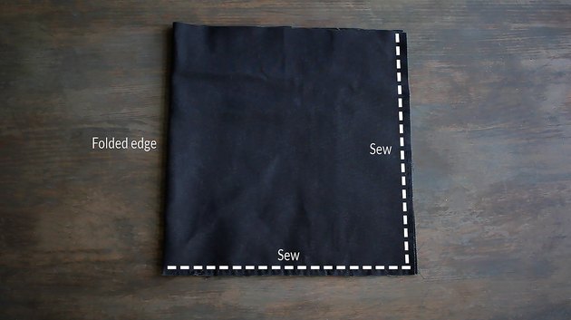 Canvas fabric folded in half with guidelines marked for sewing