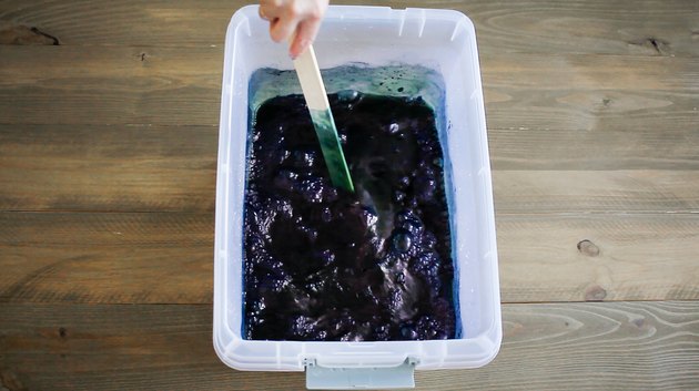 Stirring indigo dye bath