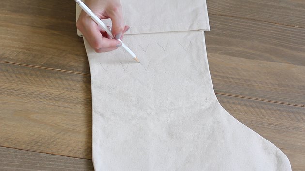 Sketching design onto canvas stocking