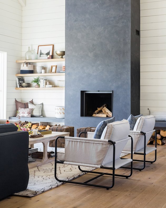 farmhouse living room with concrete fireplace and shiplap walls