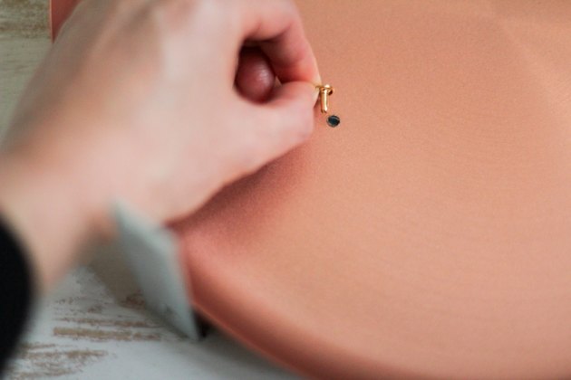 Sliding rivet through hole in platter and brace