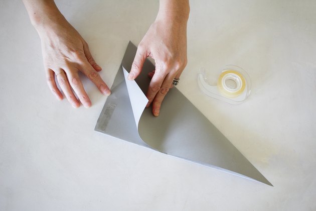 Taping paper together to make Christmas star