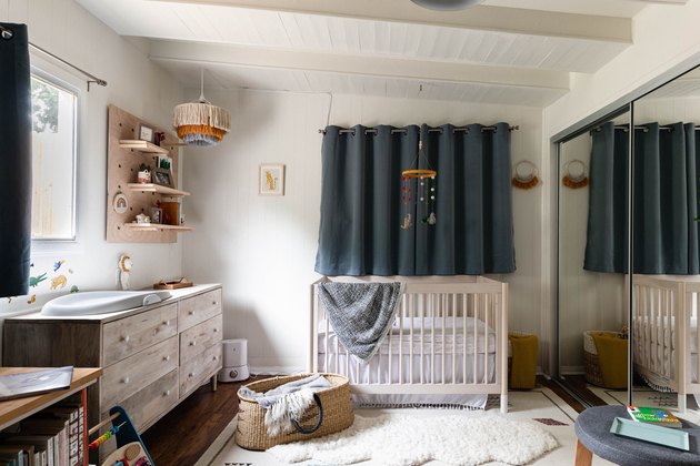 baby's room with crib, changin table and carpet