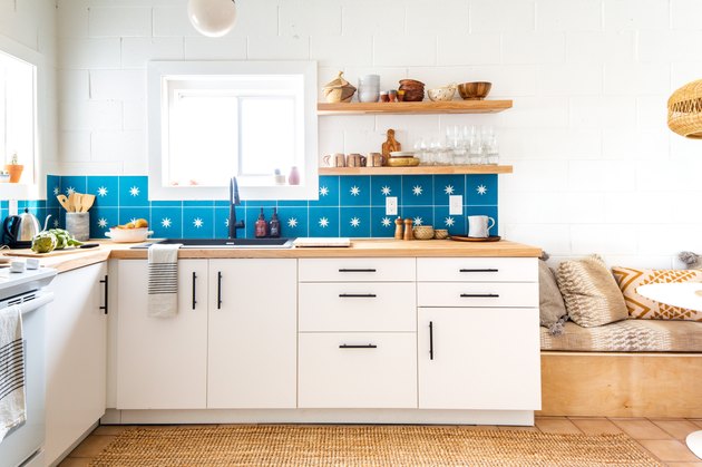 view of kitchen with blue star wall tile and tile floor