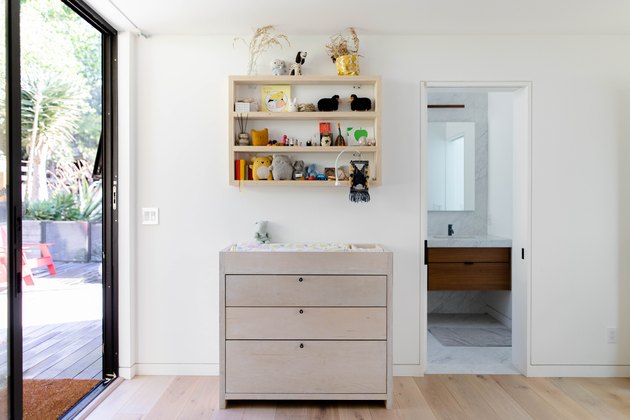 floor-to-ceiling windows and view of diaper changing table and hardwood floors