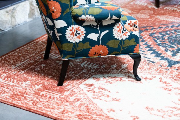 accent chair on faded Moroccan design carpet