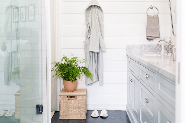 close up on robe in bathroom with blue tiled floor